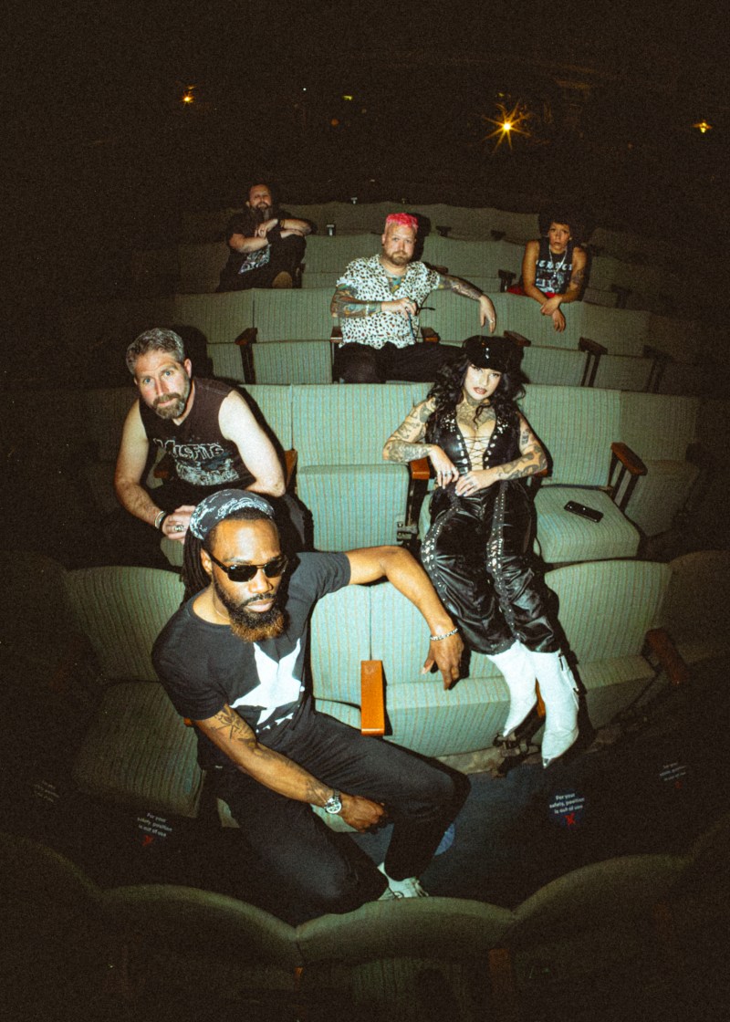 6 piece band Midwich Cuckoos sitting in a cinema