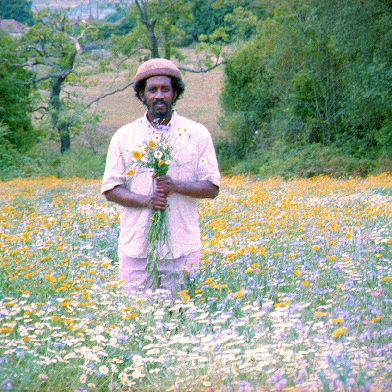 Hang Linton standing in a field of wildflowers