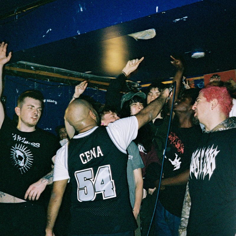 A crowd during a gig smiling